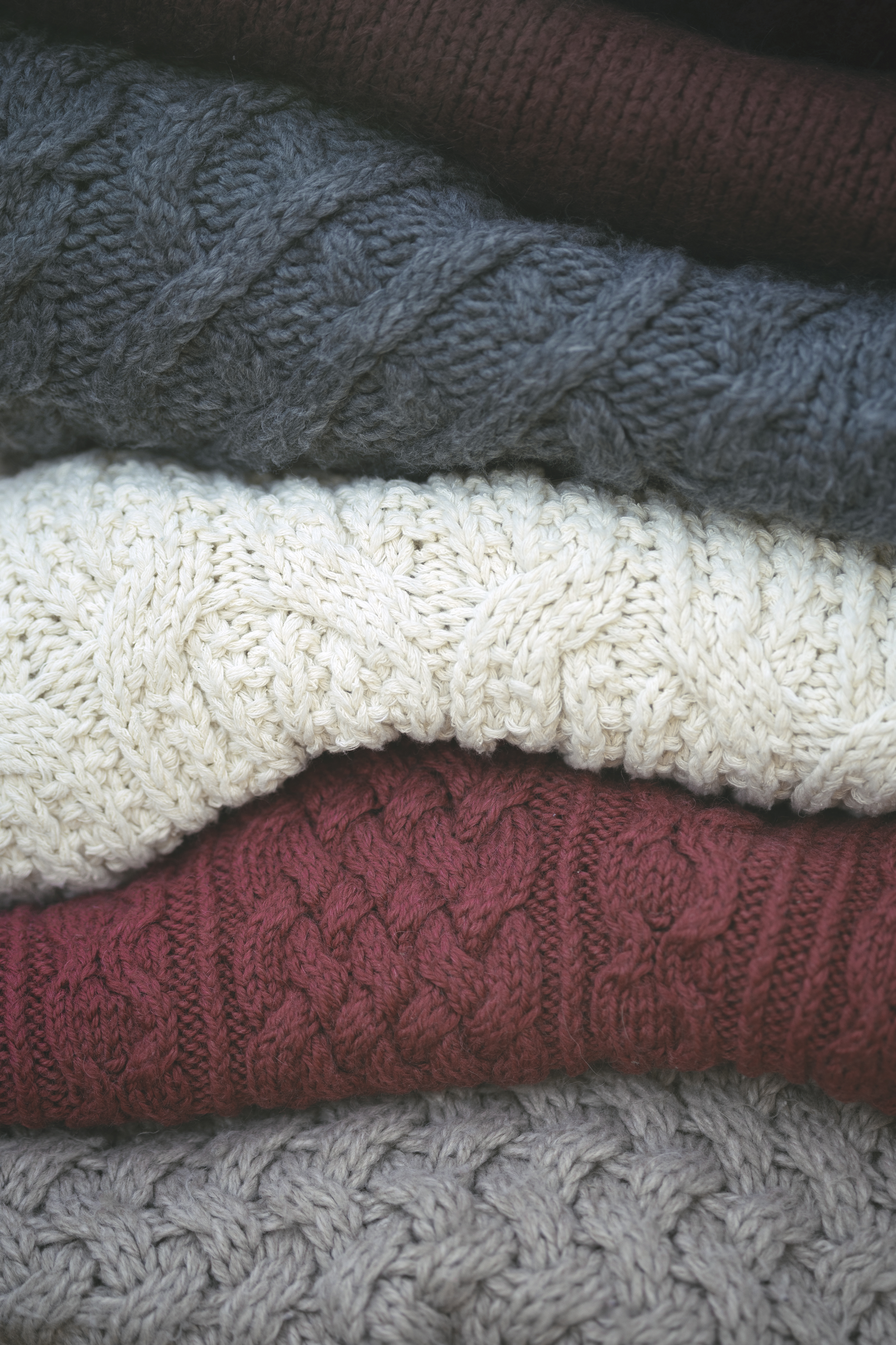 a stack of knitted sweaters